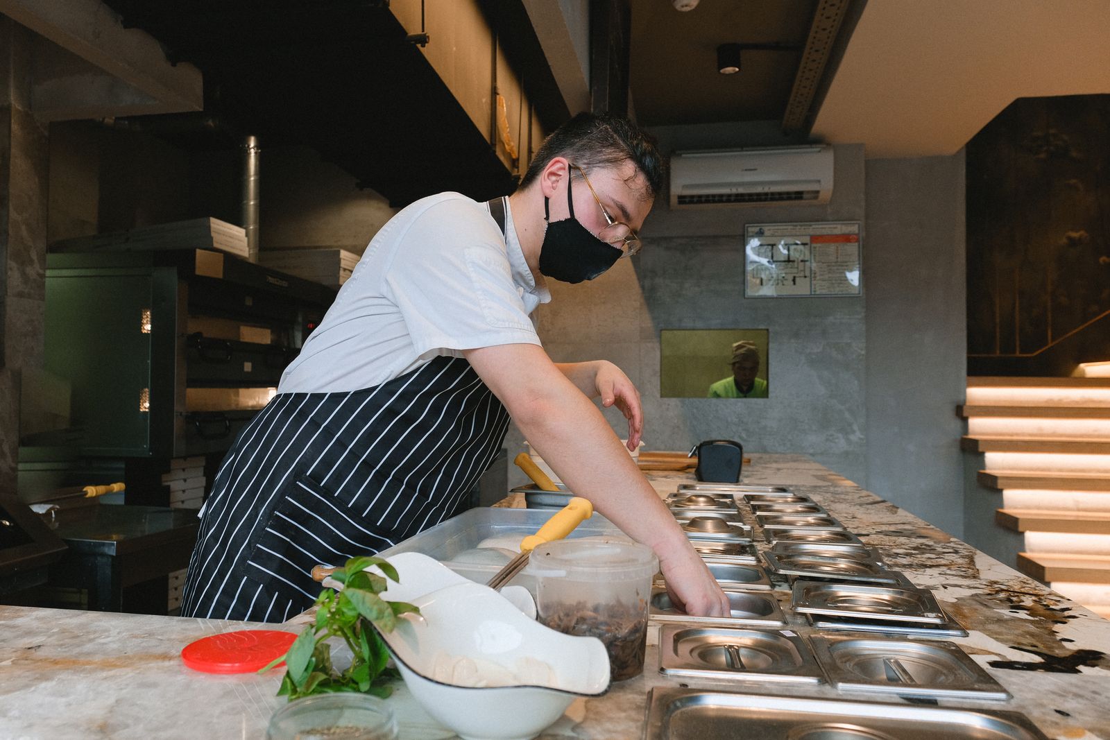 A chef at work at a bright kitchen counter